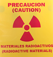 Spanish Caution Radioactive Material laminated radiation sign with grommets